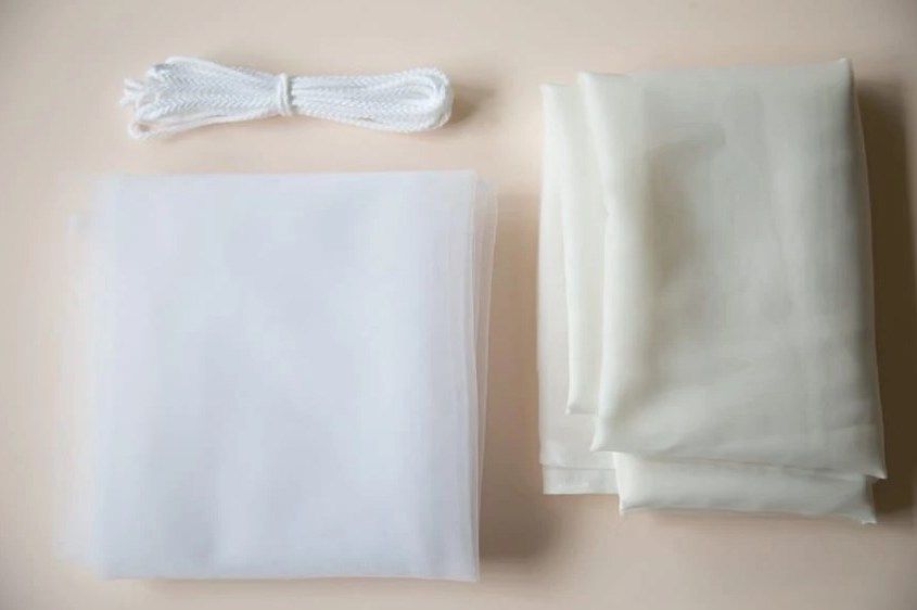Pieces of white mesh fabric and cord for eco bags