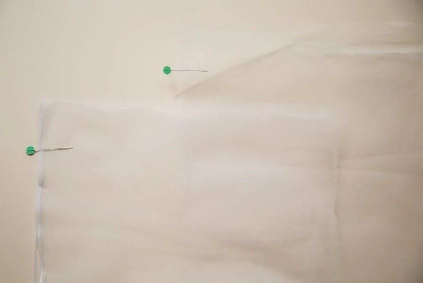 Folded mesh fabric pinned before sewing