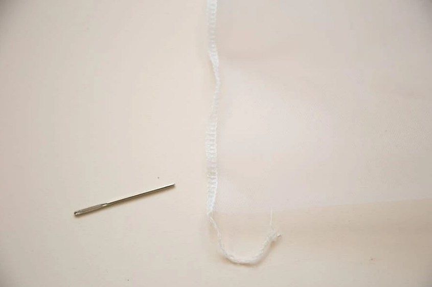 Edge of a mesh bag with a drawstring casing and cord