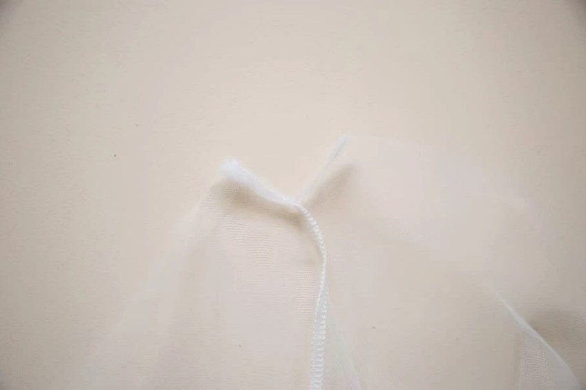 Edge of a mesh bag with the drawstring inserted