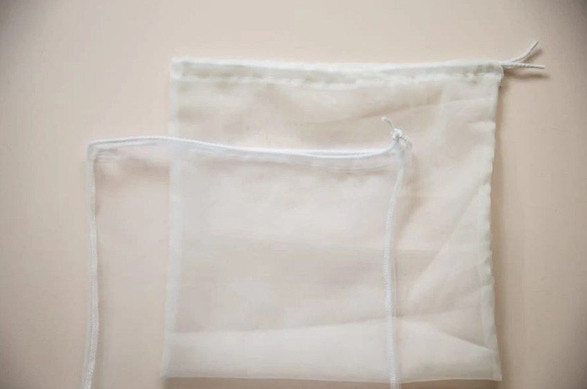 Two finished reusable mesh drawstring bags