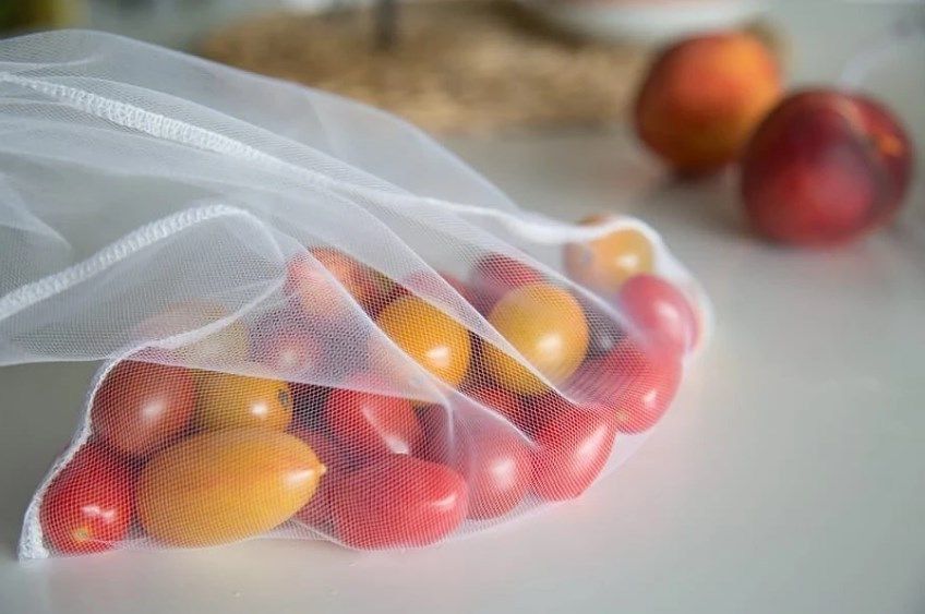Transparent mesh eco bag with small tomatoes