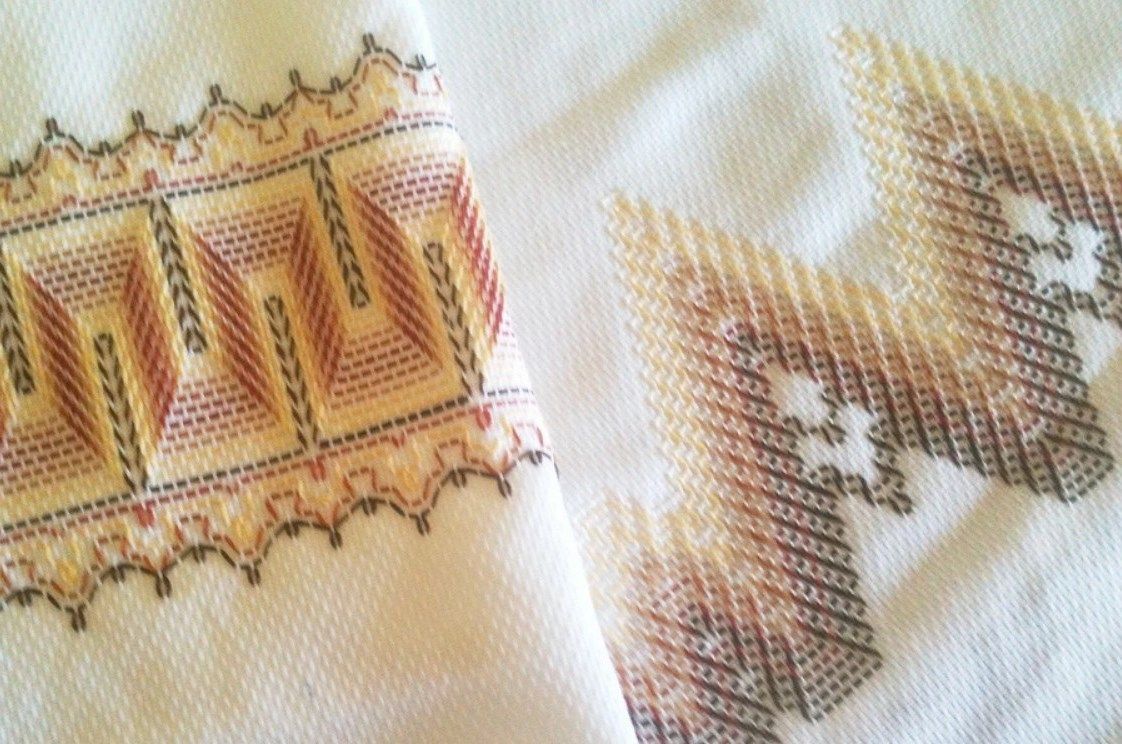 Swedish embroidery samples with geometric ornaments on light fabric