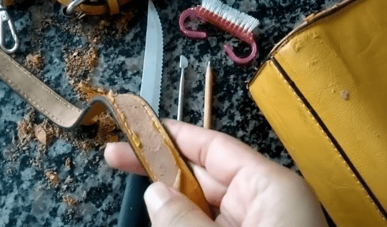 Cleaning damaged coating off the bag's strap