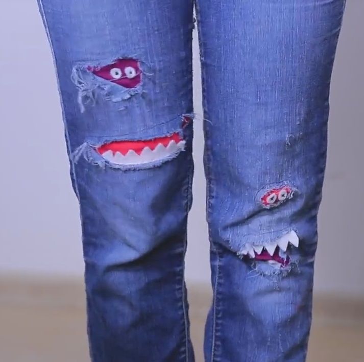 Kids' jeans with decorative patches shaped like little monsters
