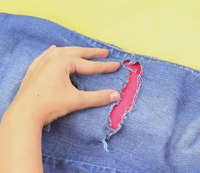 A cut in jeans with bright fabric on the wrong side
