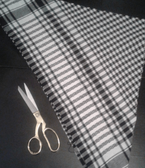 Folded plaid scarf and scissors