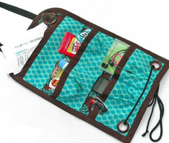 Fold-out car organizer with pockets and cords