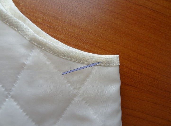Close-up of the finished bias tape seam at the armhole edge