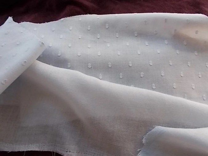 White batiste fabric with a textured dot finish