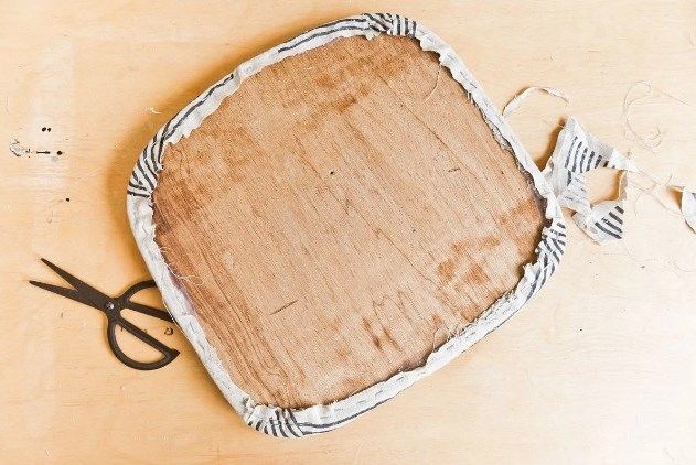 Обрізання і закріплення тканини по краю сидіння стільця