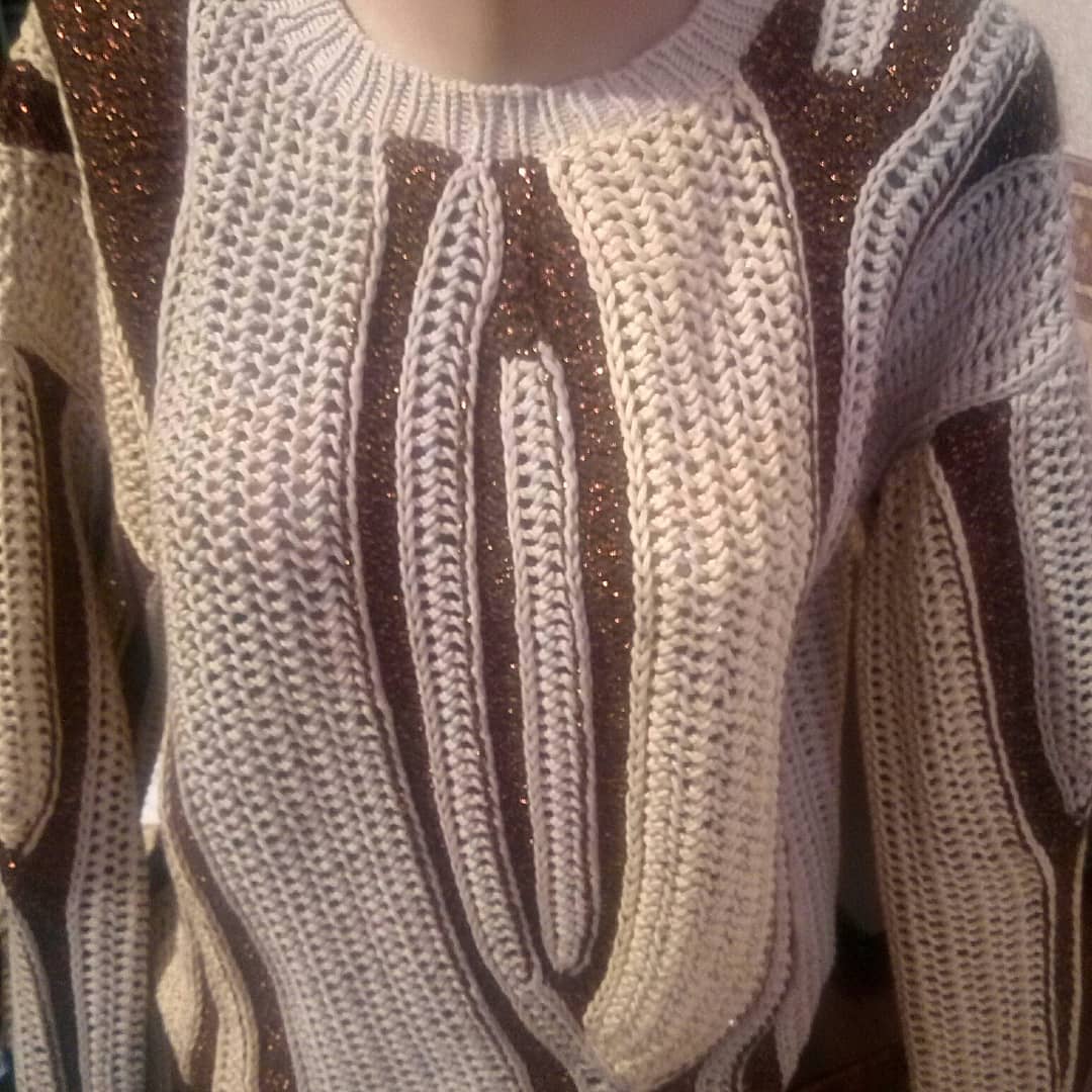 Front view of a cream and brown striped knit sweater