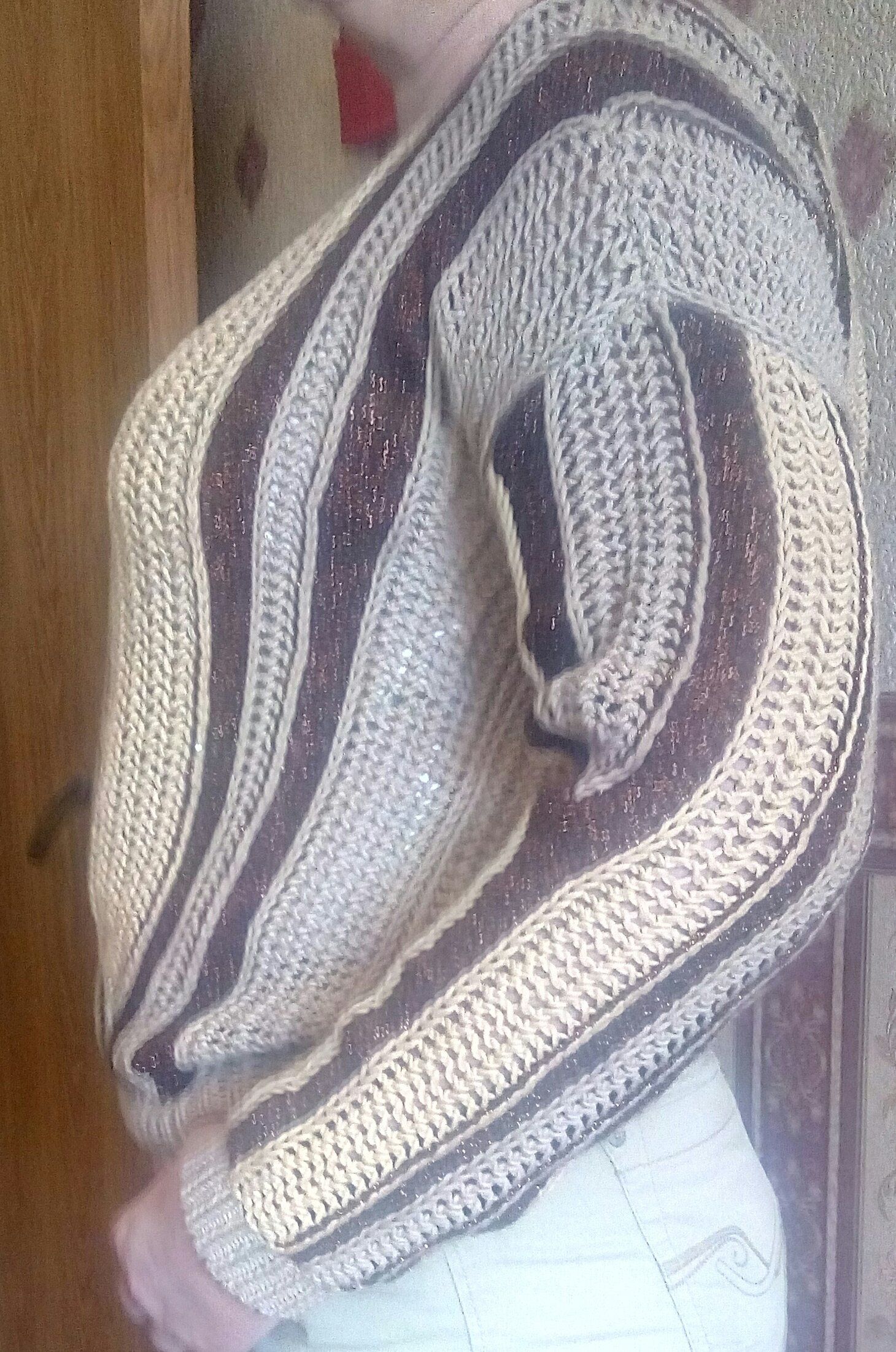 Side view of a cream and brown striped knit sweater