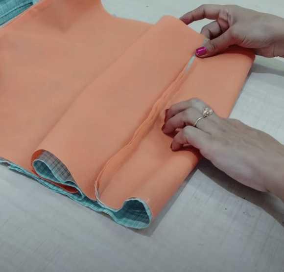 Fold for the boxed bag bottom pinned before side seams