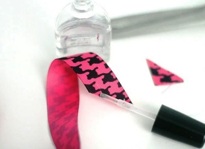 Clear nail polish applied to the cut edge of a ribbon to reduce fraying