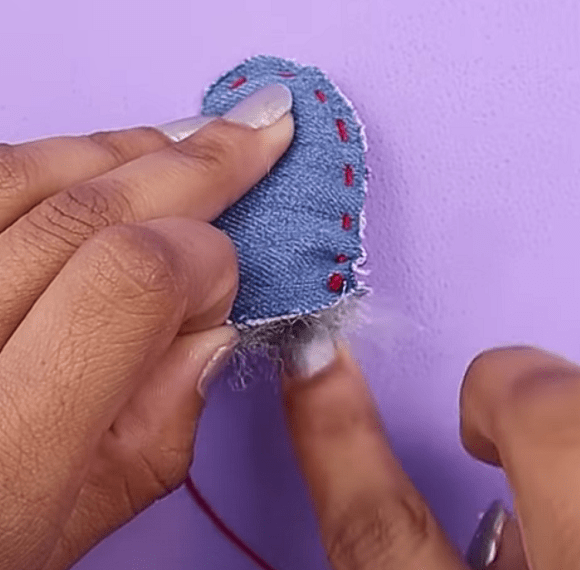 Hand-sewing the denim heart