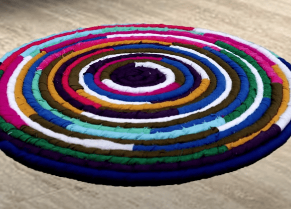 Finished round rug made from colourful fabric-wrapped rope