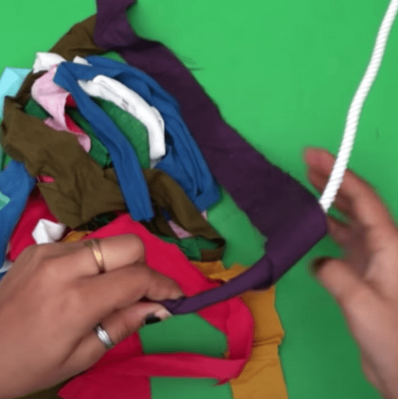 Fabric strips being wrapped around a length of rope