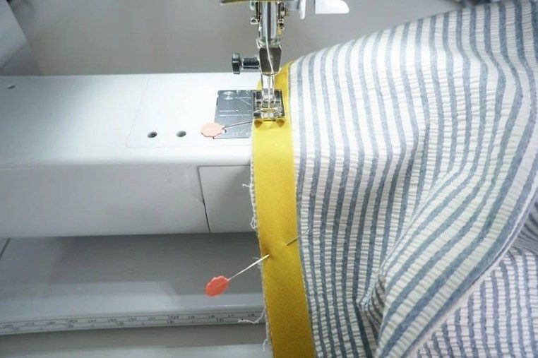 Stitching contrasting piping to a lining on a sewing machine