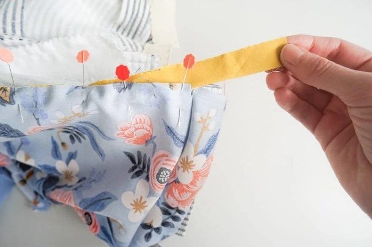 Yellow piping pinned to a jacket lining
