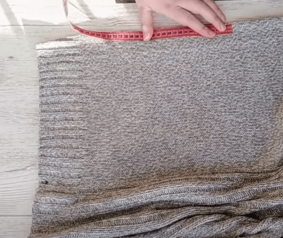 Cut-out piece from a knit sweater for the hat