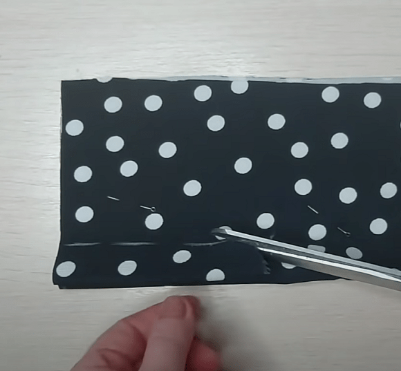 Cutting a polka-dot knit fabric footie piece
