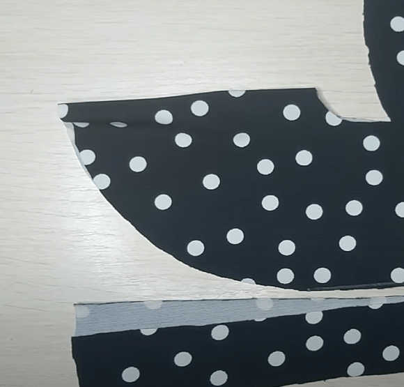Cut knit fabric footie pieces in polka-dot fabric