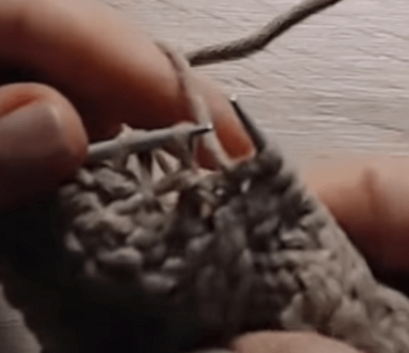 Close-up of stitches while knitting a seamless mitten