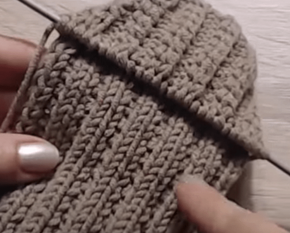 Working the main section of a mitten with knitting needles