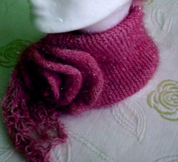 Pink knit scarf with a dimensional flower
