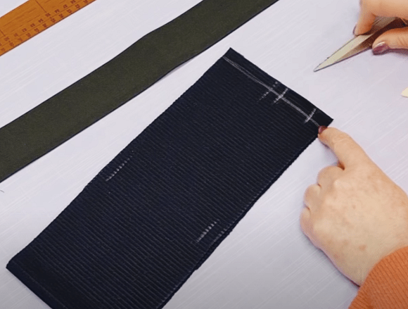 Knit waistband strip with an opening marked for elastic