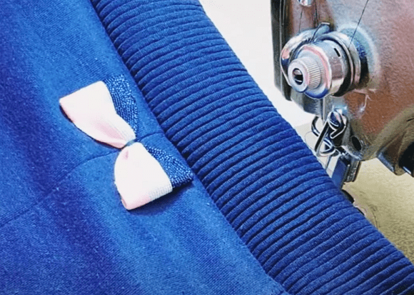 Waistband sewn to the pants with the seam edge finished