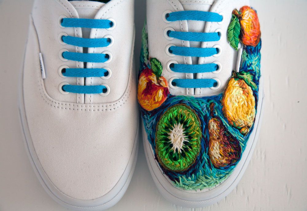 White trainers with embroidered floral panels and blue laces