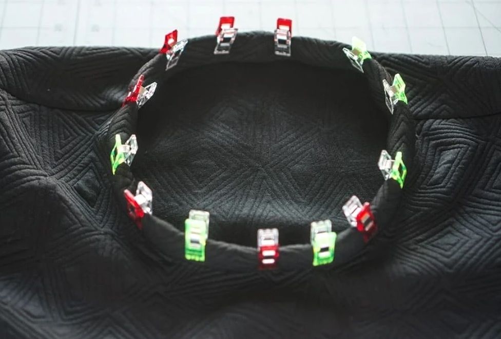 Basted or pinned neckline trim around the circumference