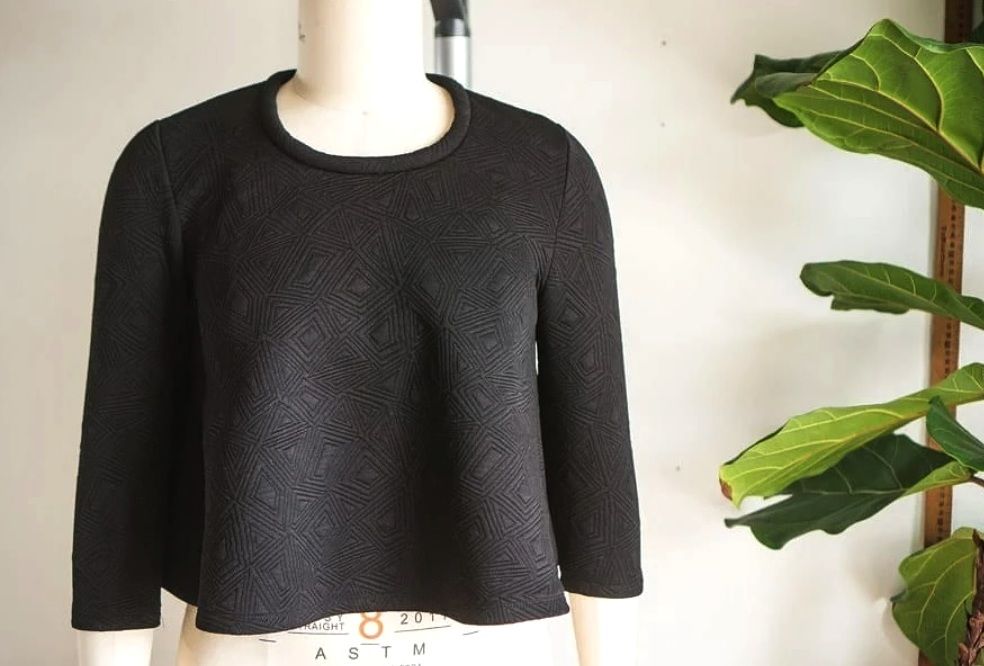 Finished black sweater with a dimensional neckband