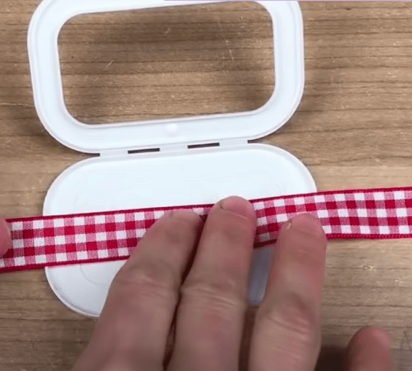 Placing the ribbon inside the lid