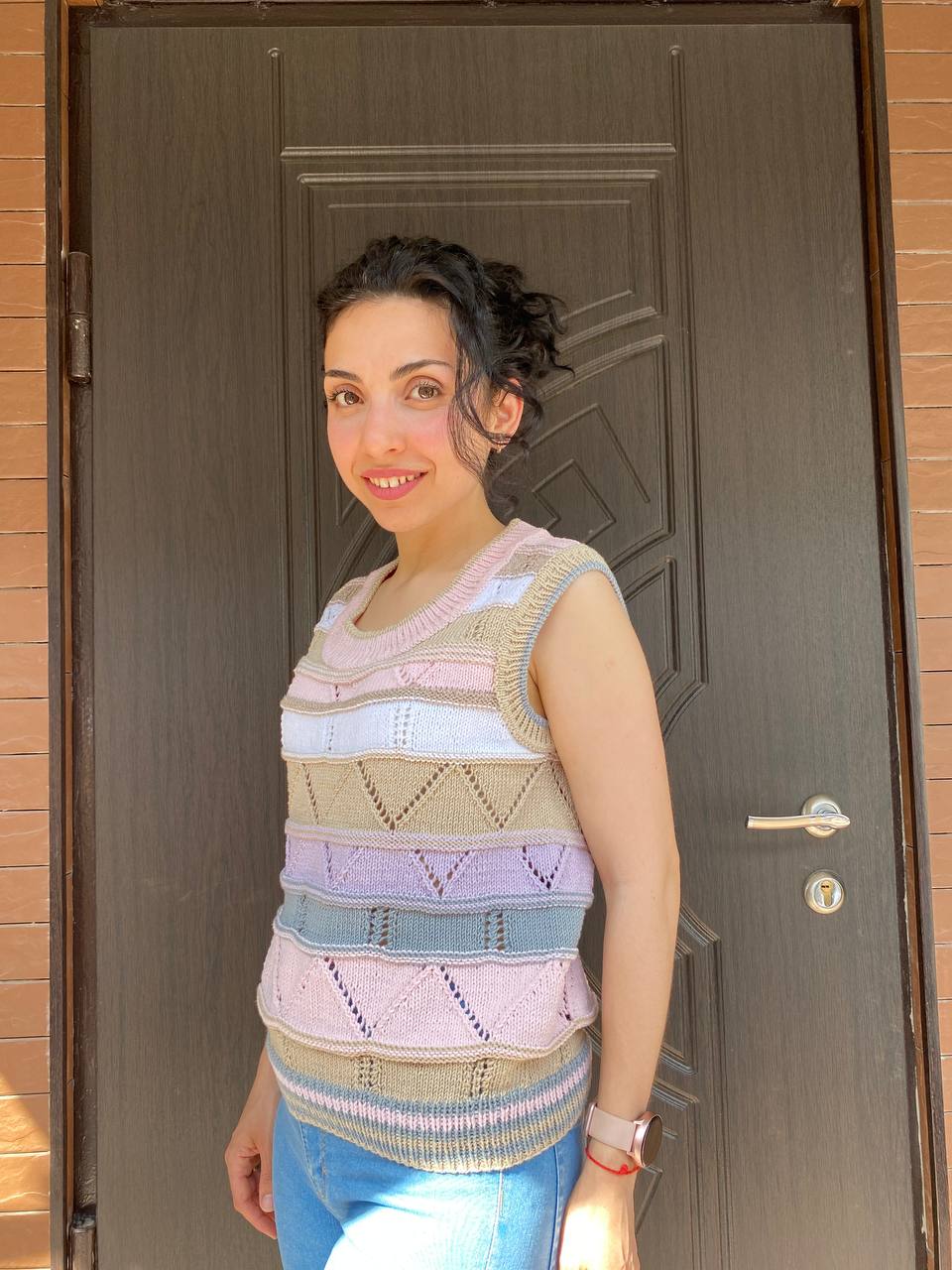 Woman in a striped sleeveless knit top, three-quarter view