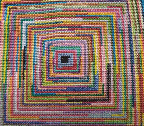 Finished multicolored square spiral worked in cross stitch