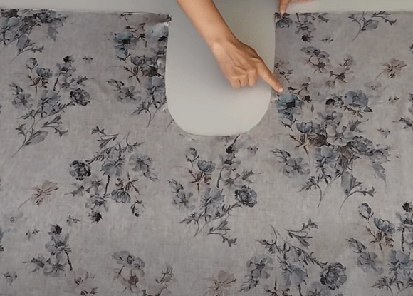 Marking the curved piece on fabric for the skirt-pants