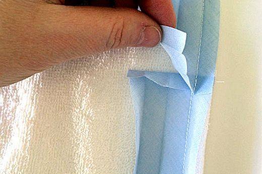 Terry cloth being stitched with paper under the presser foot
