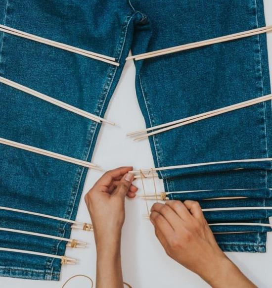 Chopsticks placed on denim