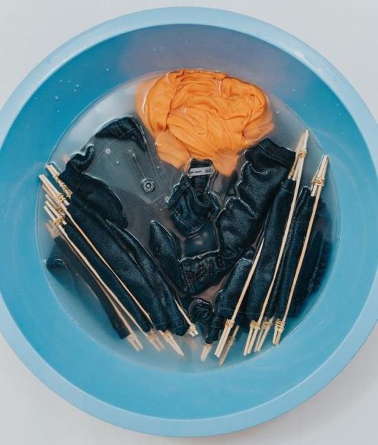 Jeans soaking in a bleach solution
