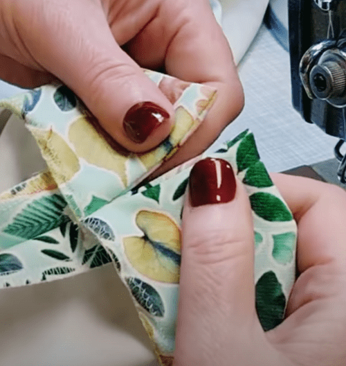 Forming the corner of the vent on the hem of a pant leg