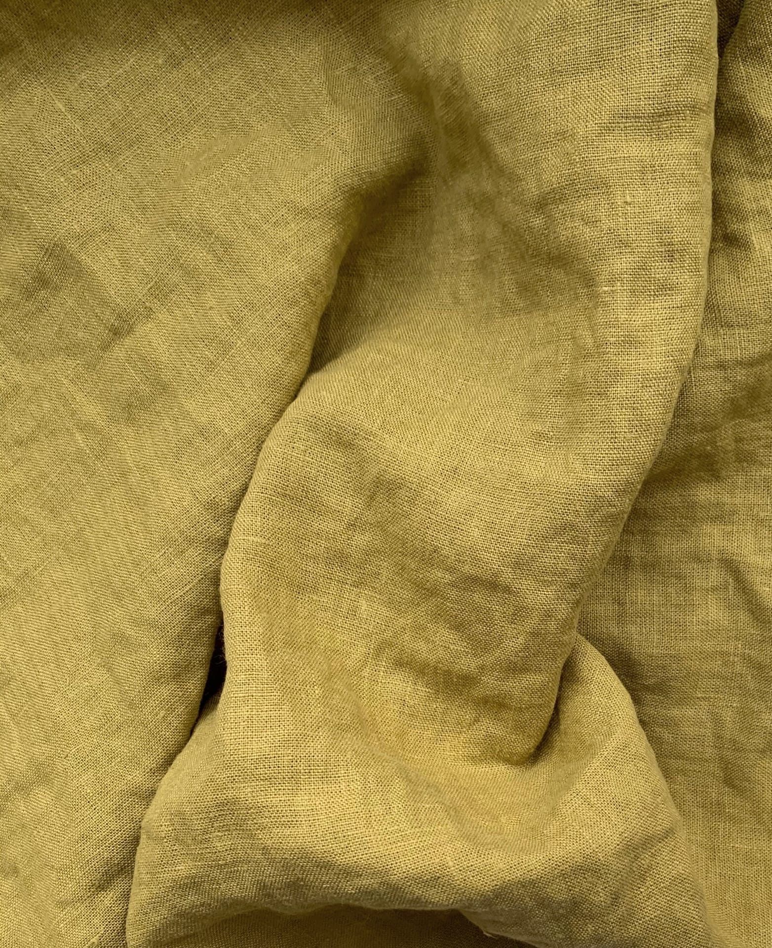 Mustard-olive washed linen with a relaxed crinkled texture