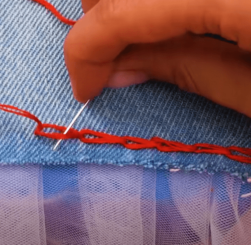 Hand sewing the ruffle with a blanket stitch