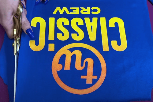 Trimming a brightly colored T-shirt with scissors