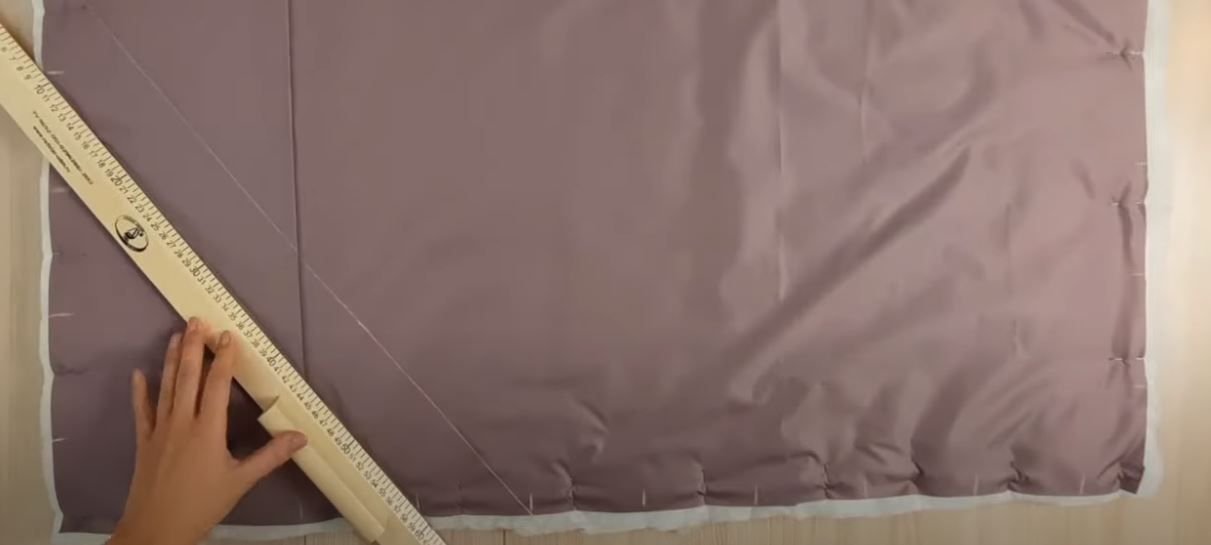 Marking diagonal quilting lines on outer fabric with insulation