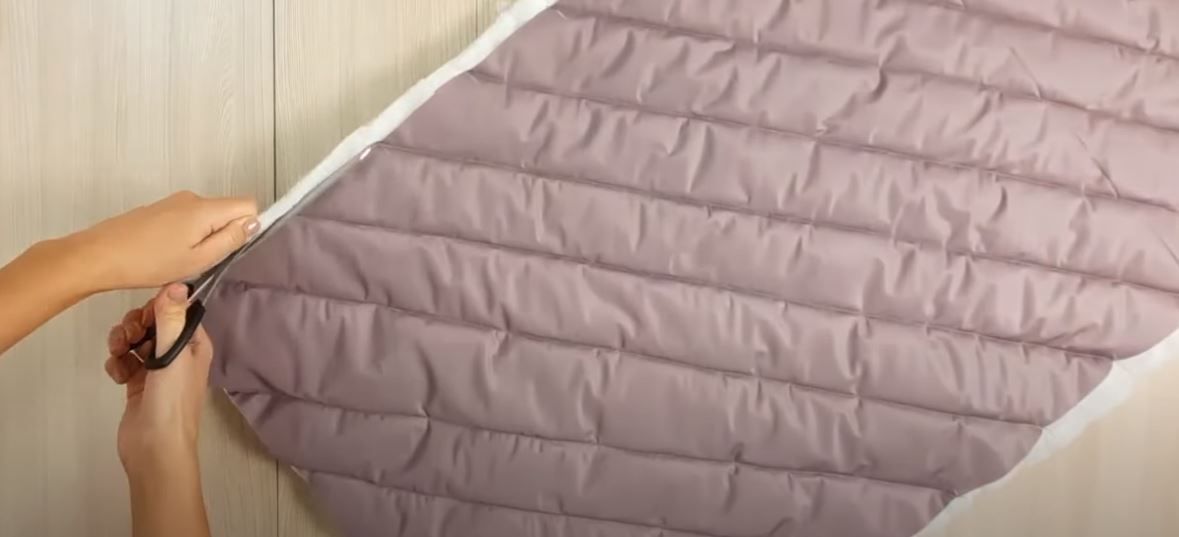 Trimming excess insulation from the edges of the quilted piece