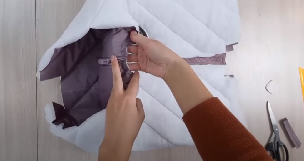Finishing one zipper end with an outer-fabric rectangle