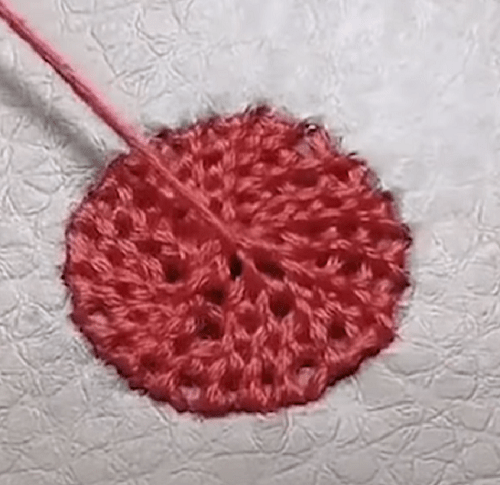 Small burn hole in leather tightened with thread